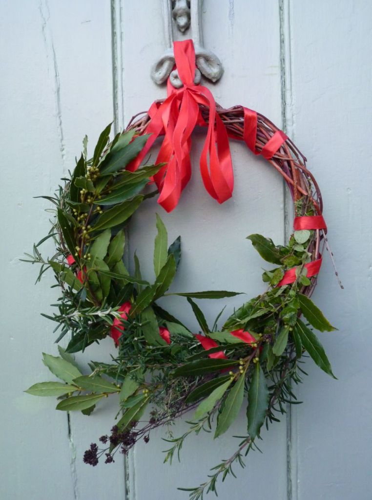 rustic wreath of herbs tied to door